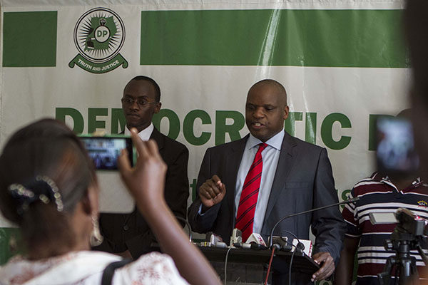 Democratic Party Spokesperson, Kenneth Paul Kakande (R) address the media at the head quarters during the party’s press conference on April 21, 2015. PHOTO BY ISAAC KASAMANI