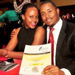 Monitor sports reporter Andrew Mwanguhya (L) poses for a picture with a friend.