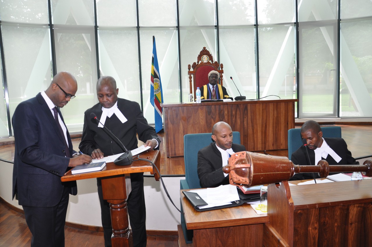 The EAC Secretary General, Hon Amb Liberat Mfumukeko signs the oath of Allegiance to the House  