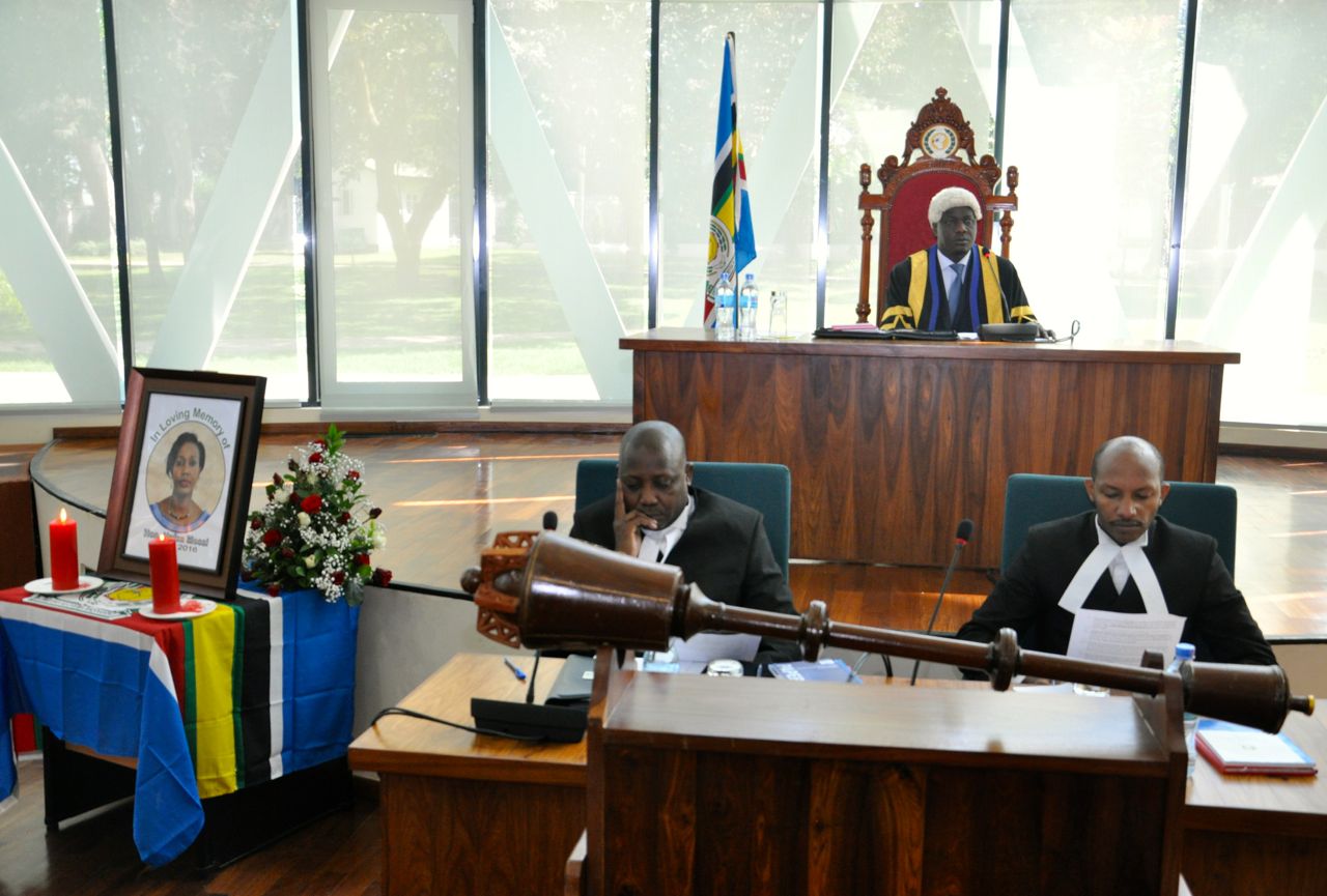 The Speaker, Rt Hon Daniel F. Kidega communicates to the Assembly at the start of the Special Sitting. In the foreground is Clerk, Kenneth Madete (left) and Senior Clerk Assistant, Stephen Mugume 