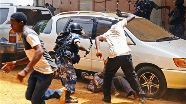 Uganda Police do what they do best. (Photo/AFP)