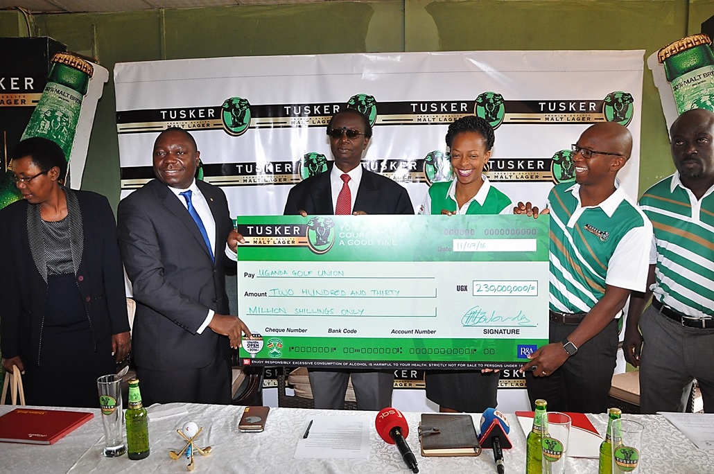 UBL Managing Director Mr. Nyimpini Mabunda hands over the dummy cheque to Johnson Omolo the President of the Uganda Golf Union