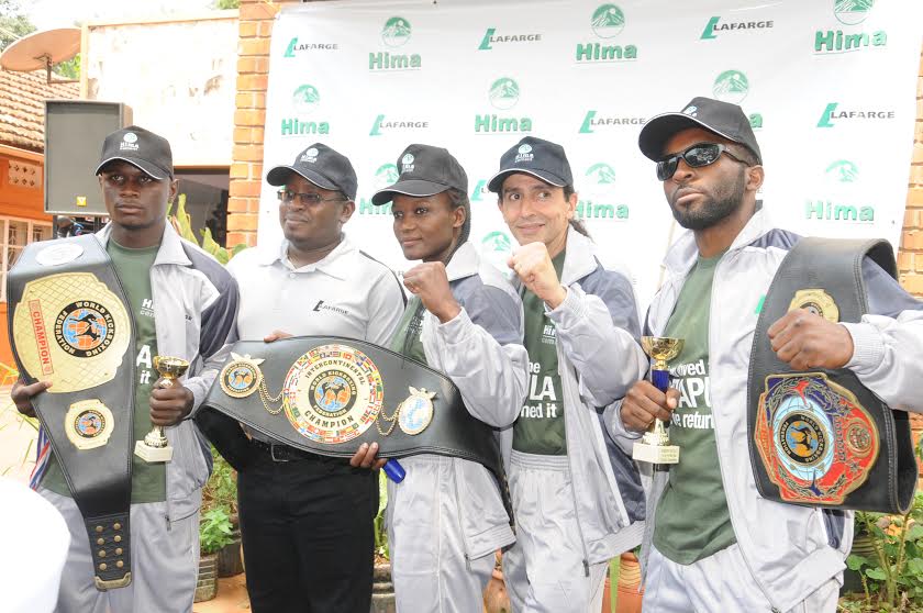 HIMA Cement’s Marketing Director Allan Ssemakula 2nd from left poses with kickboxers Patricia Apolot, Alex Masiko, and Shakey Mubiru with their coach Adam Boumadi after they returned from a successful trip in Hungary for the World Kickboxing Championships.
