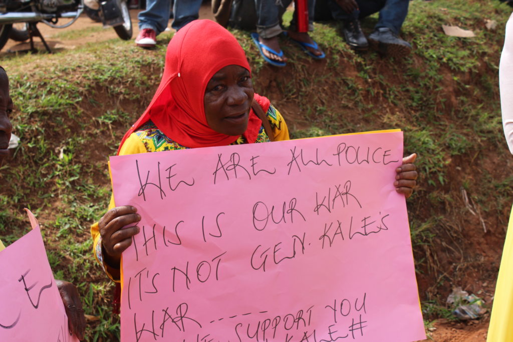 Placard holding supporters of police IGP General Kayihura