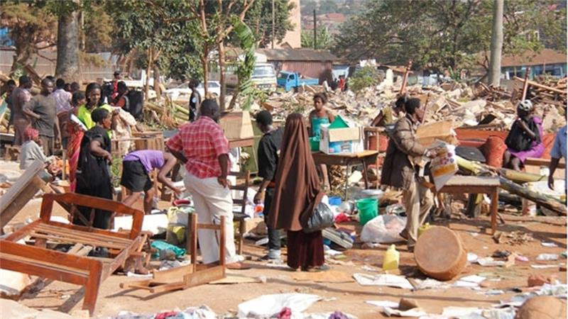 DEMOLISHED: Parents sort through the rubble for their children's belongings at the site of the demolished Nabagereka Primary School. Photo credit/Aljazeera