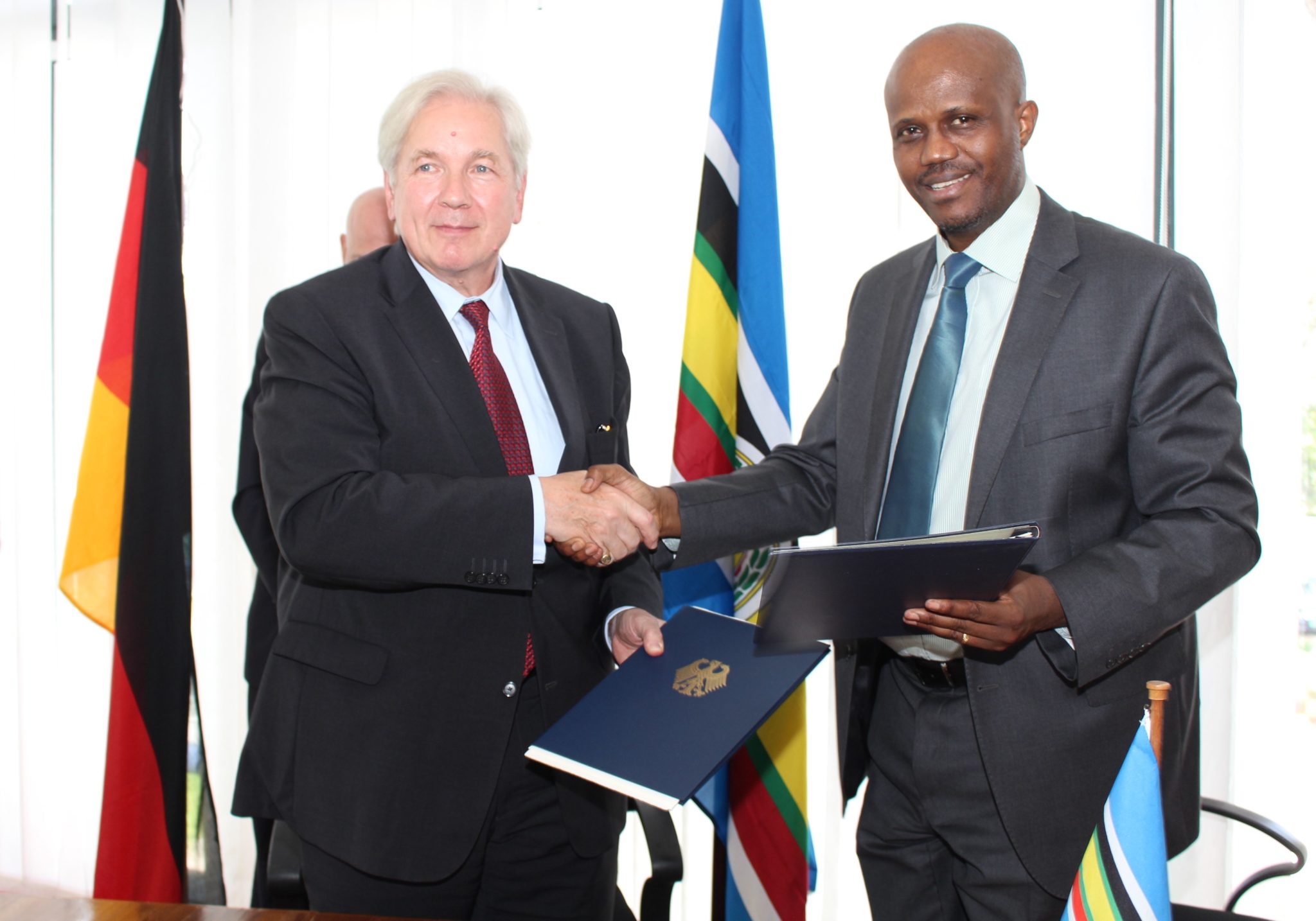 Amb. Liberat Mfumukeko and Ambassador of the Federal Republic of Germany pose for a picture after initialled Financing Agreement.