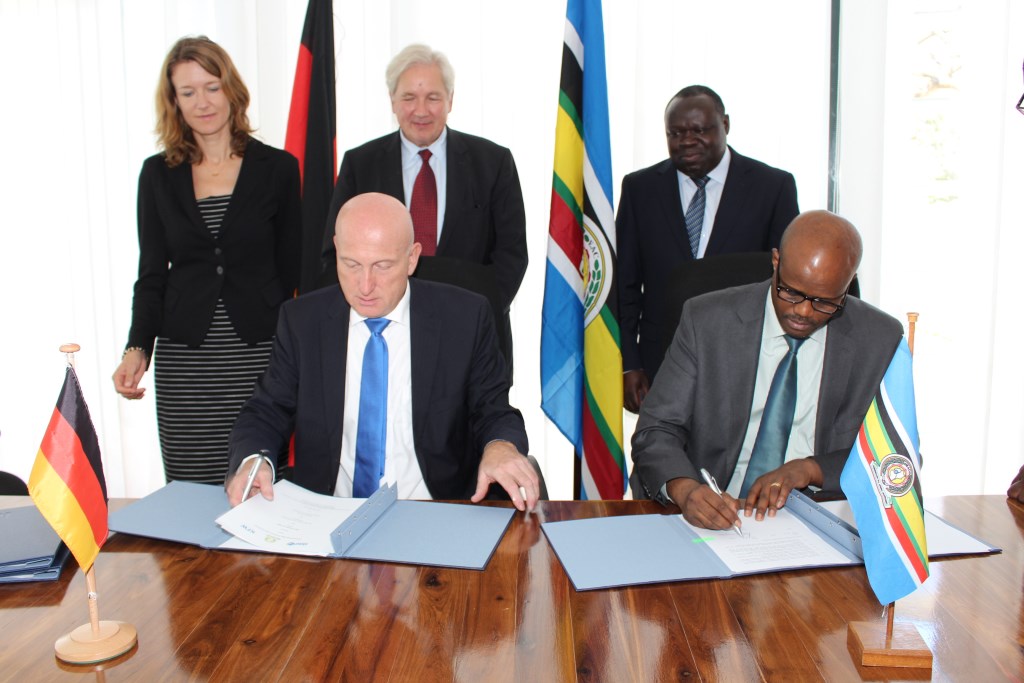 Secretary General of EAC , Amb. Liberat Mfumukeko signs the second agreement with KfW Development Bank Director, Dr. Helmut Schon.