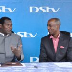 Charles Hamya (R) General Manager MulitChoice Uganda listens as Pastor Robert Kayanja addresses media at the launch of Channel 44 on DStv platform.JPG