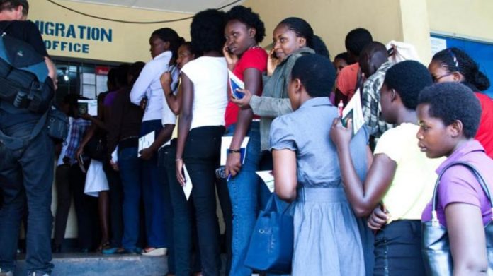 Travellers wait to becleared at Rusumo border recently