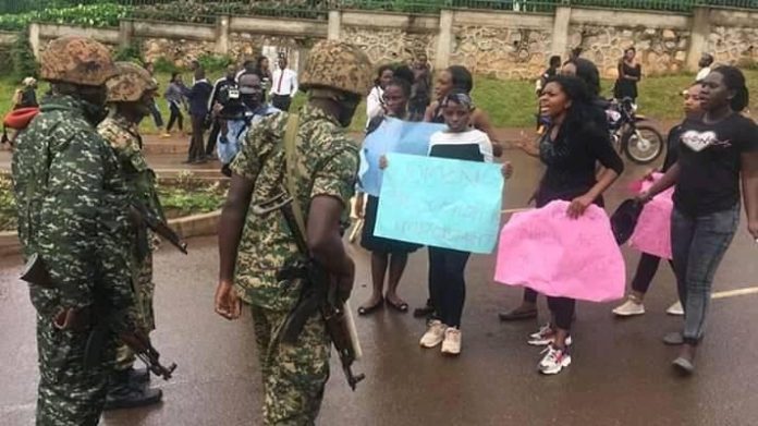 Soldiers confronting Makeerere students who were holding a peaceful demomstration