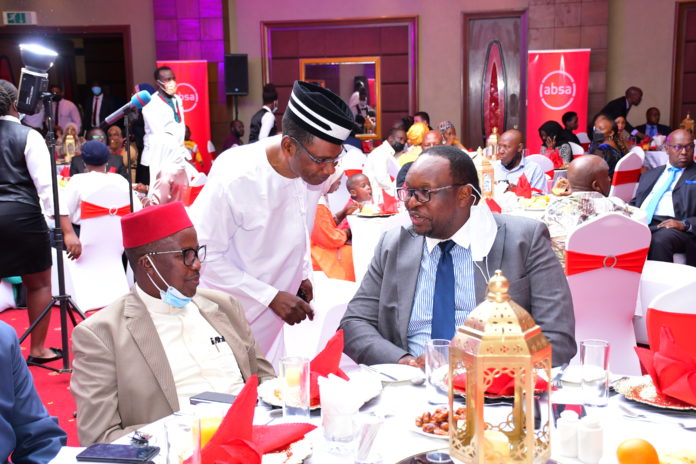 ABSA MD interacts with one of the bank clients as Dr Ssali Ebraheem looks on