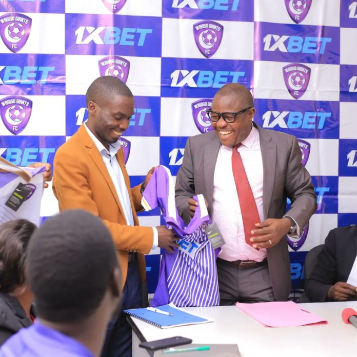 Club CEO Sula Kamoga with District Chairperson Matia Lwanga Bwaniika