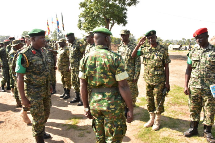 Lt Munanura Emmanuel-Cont Legal Offr salute Gen Ignace while inspecting Offrs