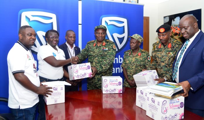 Diana Ondoga(second left) handing over a Mama Kit to Brig Gen Michael Kibuye at the Ministry of Defence Headquarters in Mbuya